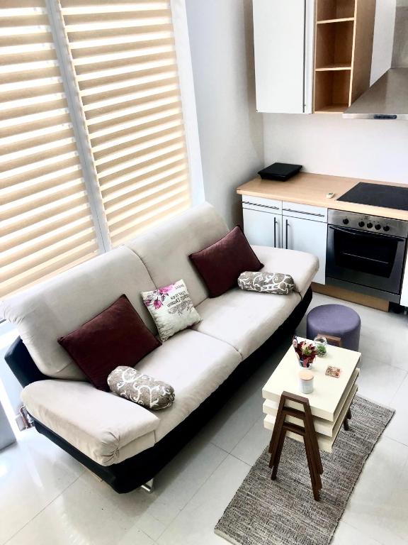 a living room with a white couch and a table at Apartment Duplex in Pančevo