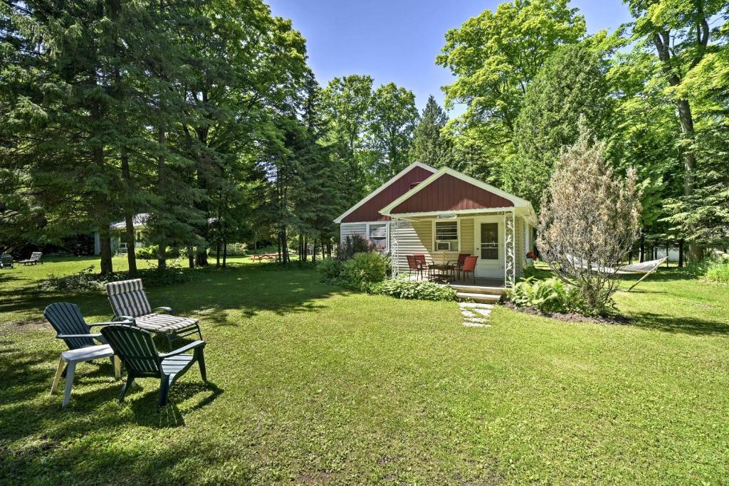 a yard with two chairs and a cabin at Ephraim Vacation Rental - 3 Mi to Fish Creek Beach in Ephraim