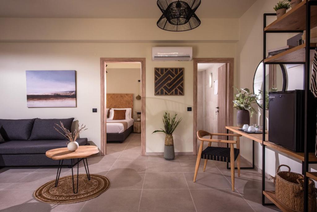 a living room with a couch and a table at Malena Hotel & Suites - Adults Only by Omilos Hotels in Amoudara Herakliou