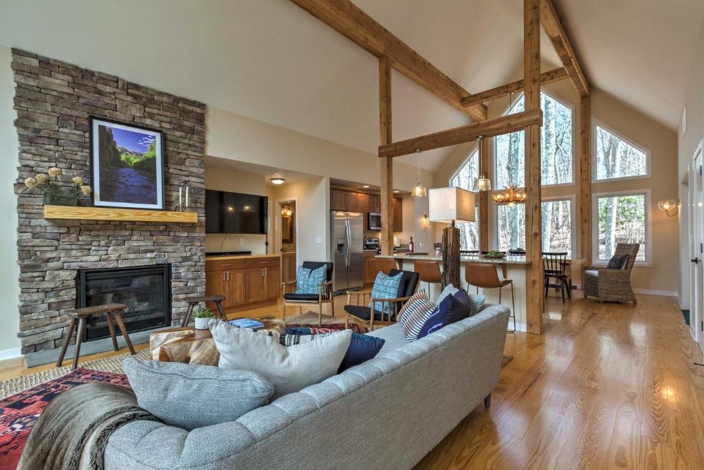 a living room with a couch and a fireplace at Designer Home with Fire Pit about 70 Steps to Slopes! in Wintergreen
