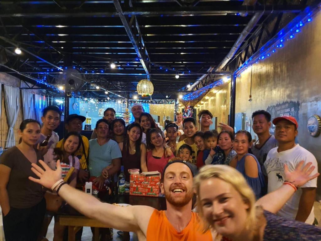 a large group of people posing for a picture at Big Paul Hostel in El Nido