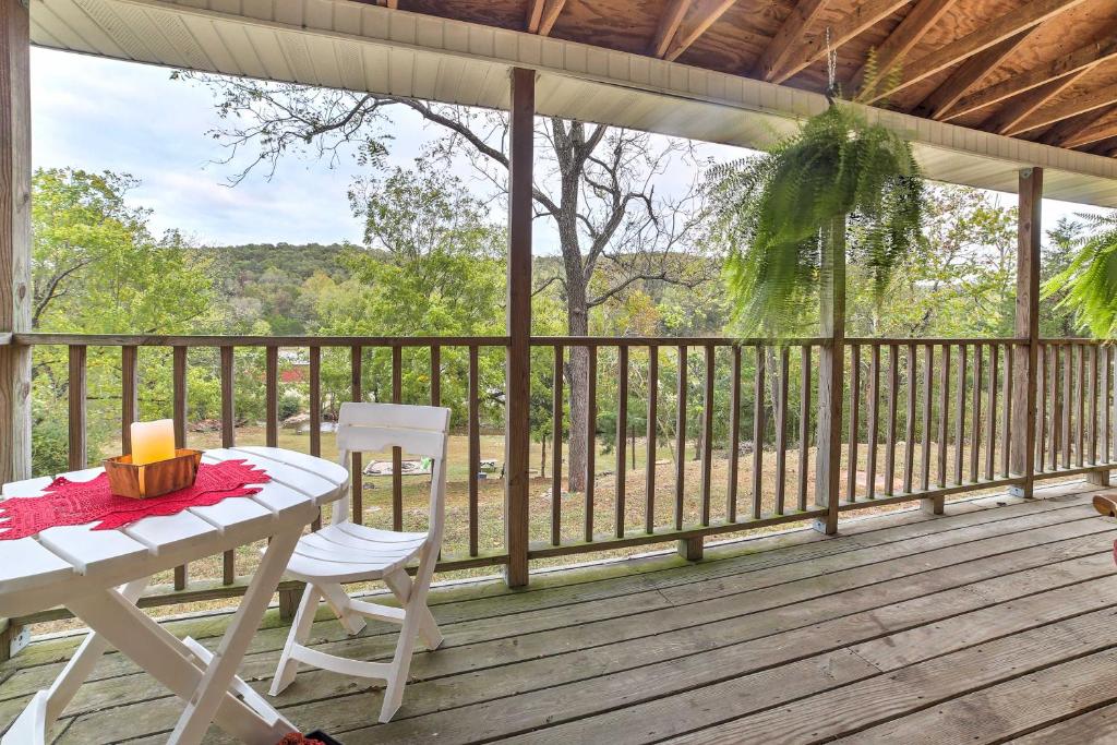 a porch with a table and chairs on a deck at Historic Bruno Hampton Creek Hideaway on 2 Acres in Everton