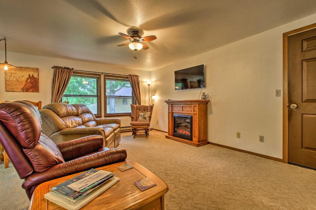 a living room with a couch and a fireplace at Cozy Anglers Apt - Steps to Trout Fishing River! in Columbus