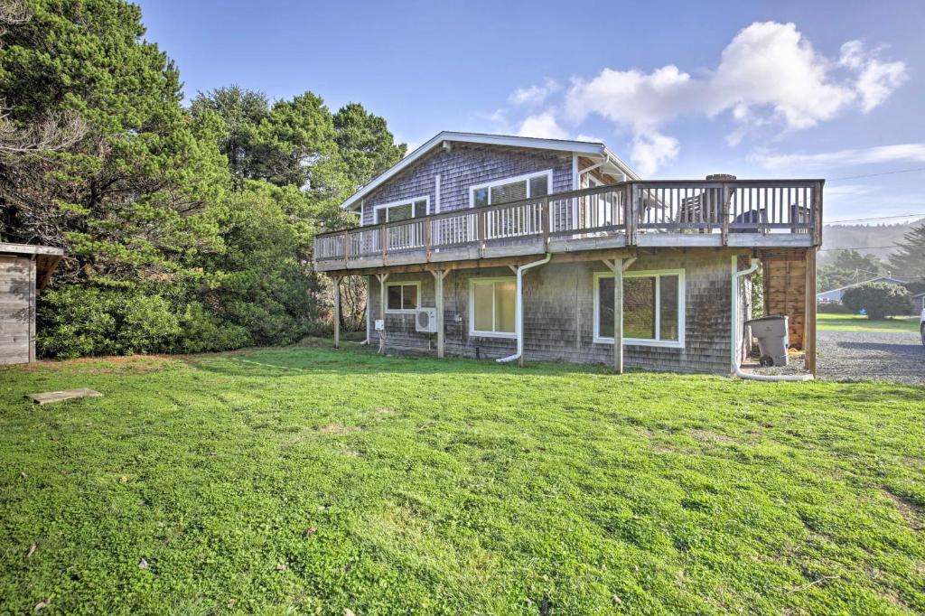 a house with a deck on top of a yard at Private Rockaway Beach Retreat 2 Blocks to Ocean! in Rockaway Beach