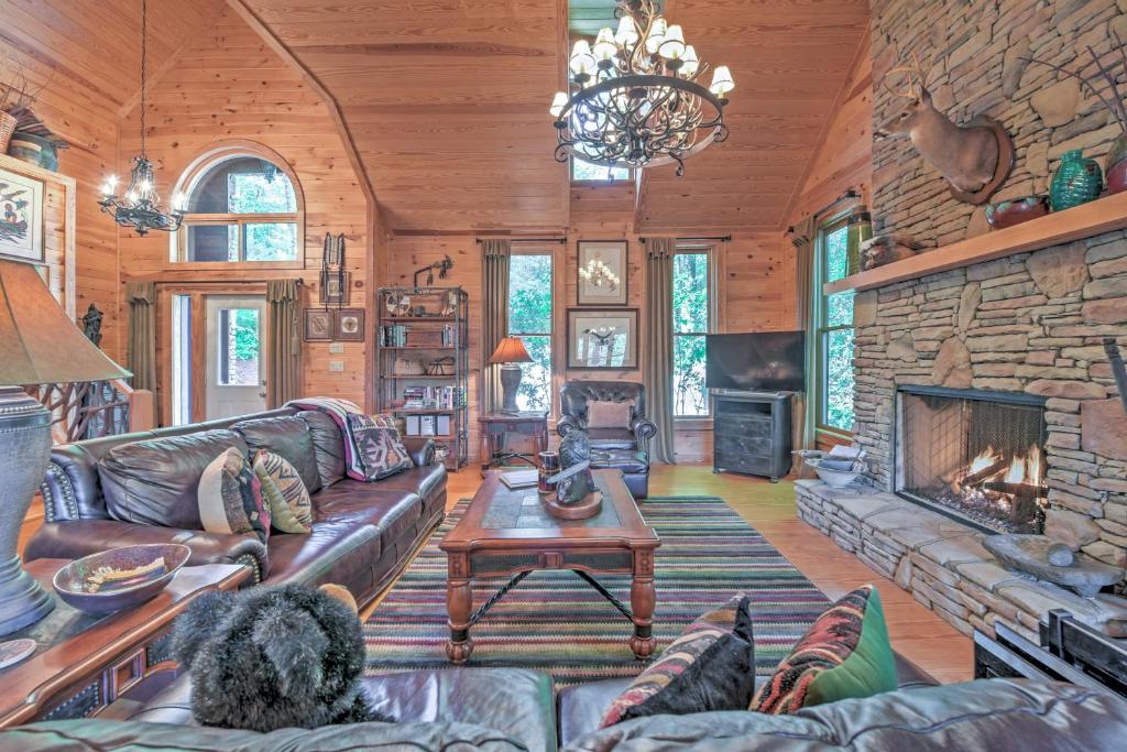 a living room with a couch and a fireplace at Dream Catcher Luxe Cabin with Large Deck and Mtn View in Sapphire