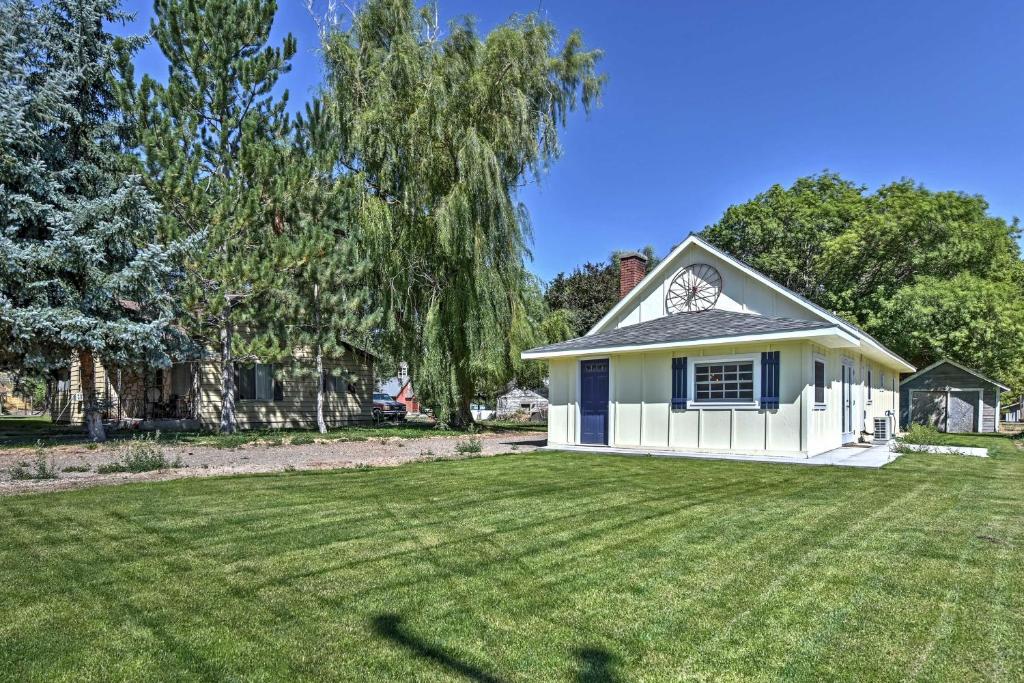 a small white house with a large yard at Historic Albion Mountain Cottage on Quiet Street! in Albion