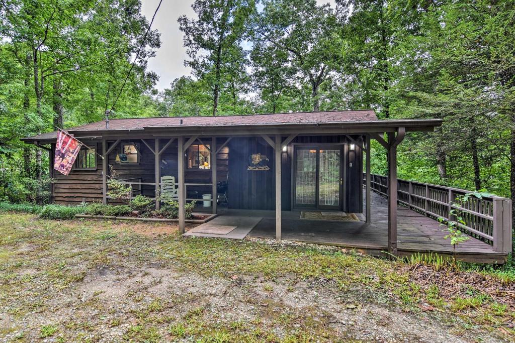 a cabin in the woods with a porch at Robbinsville Cabin with Deck 3 Mi to Fontana Lake! in Robbinsville