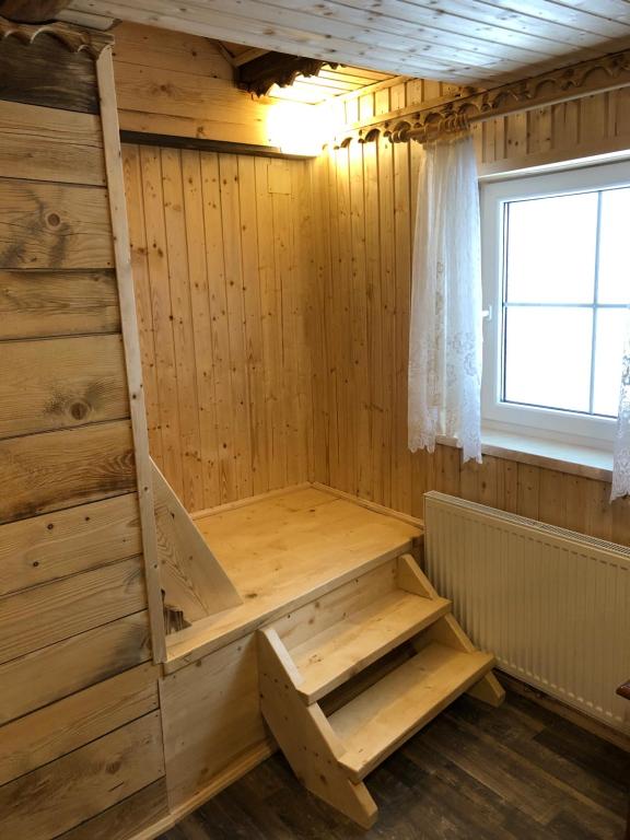 a sauna with a ladder in a wooden room at Einser Hütte GesbR - Selbstversorgerhaus für 7 Personen in Vordernberg