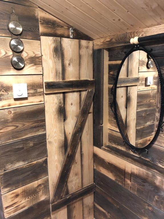 a room with a wooden wall with a mirror at Einser Hütte GesbR - Selbstversorgerhaus für 7 Personen in Vordernberg