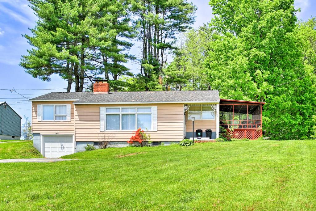 a house with a lawn in front of it at Mayfield Home with Private Dock on Lake Sacandaga! in Broadalbin