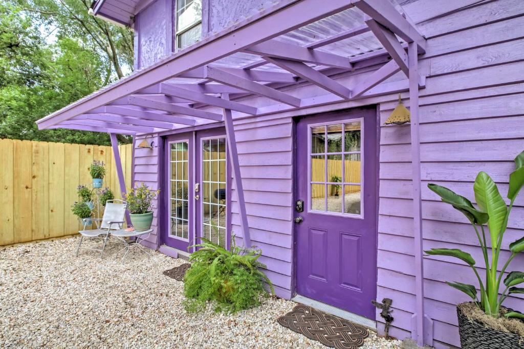 a purple house with a purple door and a pergola at Historic Apt with Backyard - Mins to DT Jacksonville! in Jacksonville