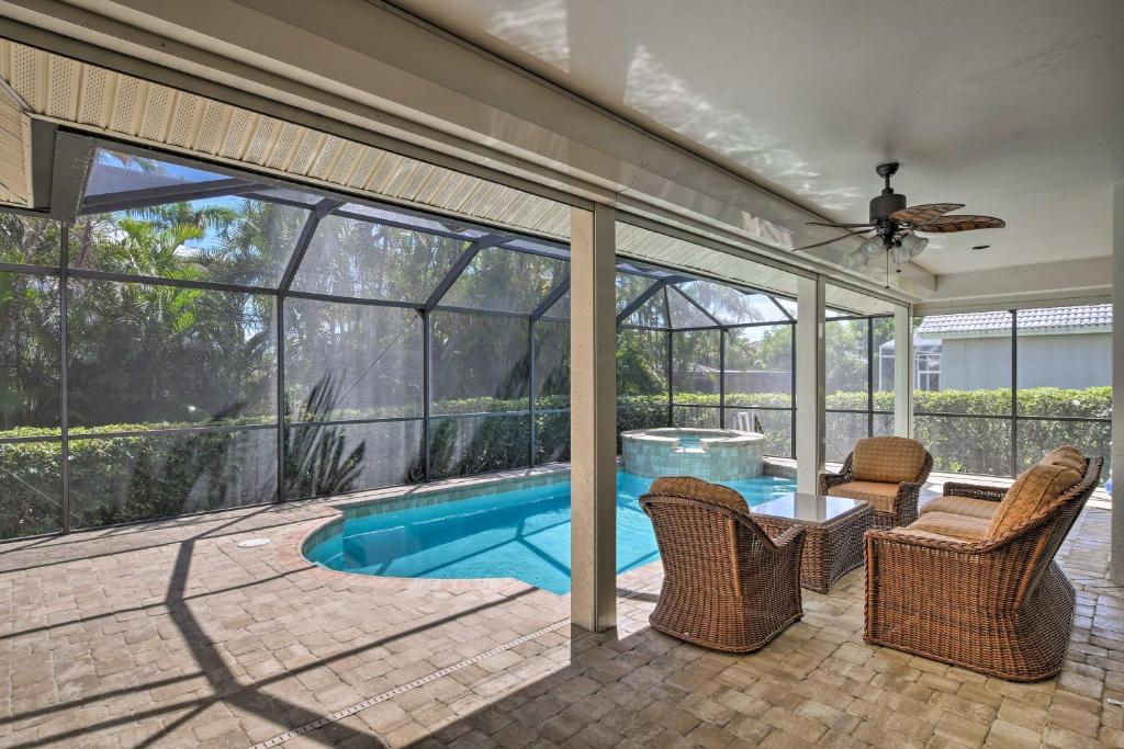 a house with a swimming pool and a patio at Marco Island Home with Pool and Lanai Less Than 1 Mi To Beach in Marco Island