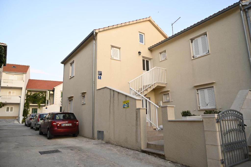 a car parked in a parking lot next to a building at Apartments "sea view" Miki & Ivana in Bol
