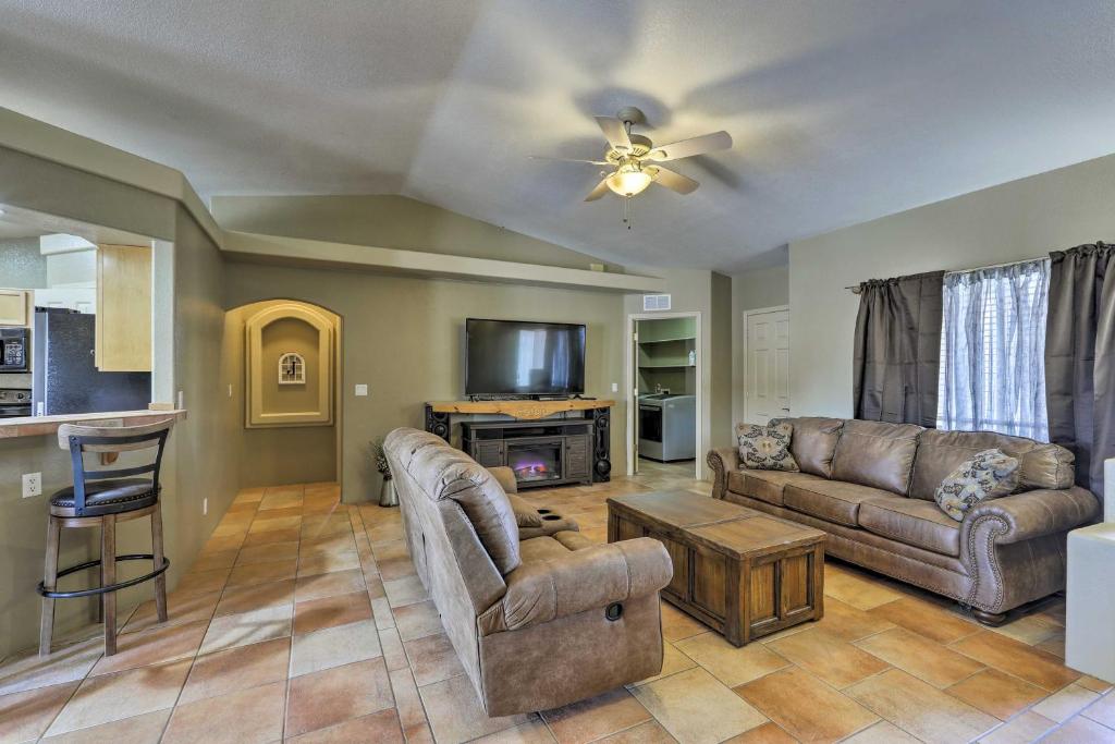 a living room with a couch and a table at Lake Havasu Getaway with Patio - Hike, Swim, and Golf! in Lake Havasu City