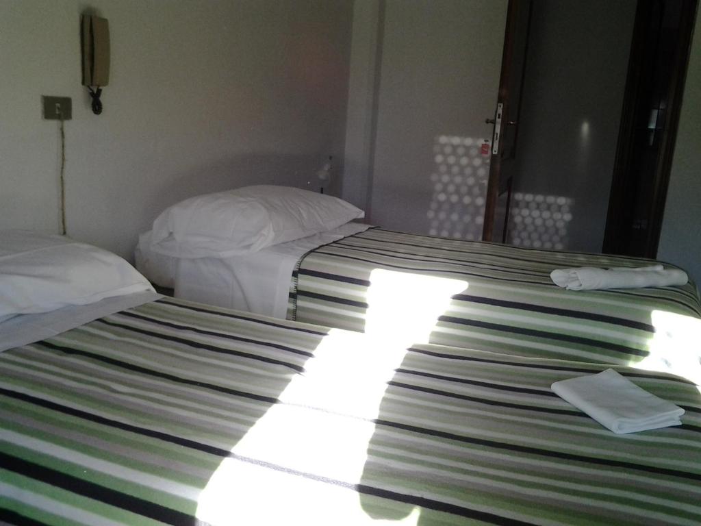 Postel nebo postele na pokoji v ubytování Hotel Guesthouse MASSENA
