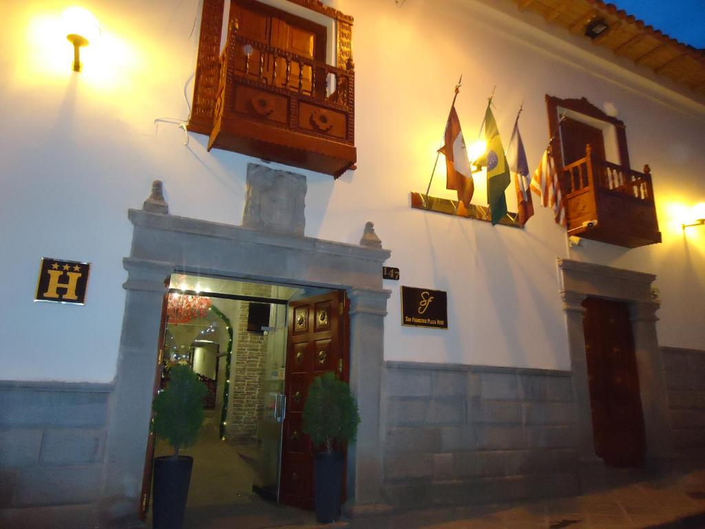 a building with a door and someitures on it at Hotel San Francisco Plaza in Cusco