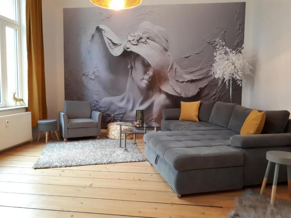 a living room with a couch and a painting on the wall at Patio 4 in Bremen