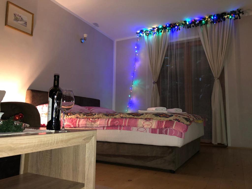 a bedroom with a bed with christmas lights on it at Apartmani Sredojevic in Kaludjerske Bare