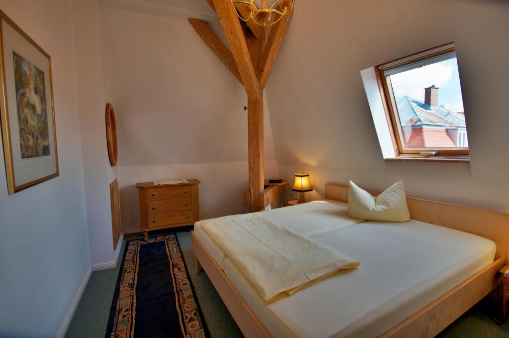 a bedroom with a bed with a tree on the wall at Altstadt Appartements in Augsburg