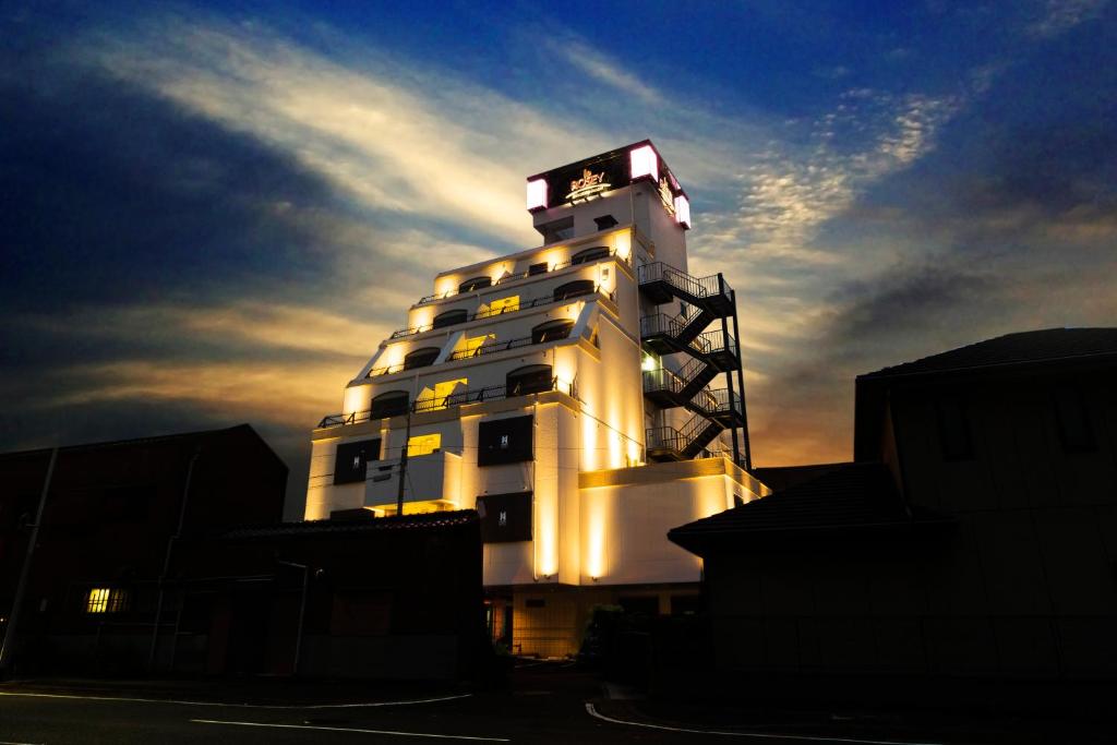 a white building with a clock on top of it at HOTEL le ROSEY in Kitakyushu
