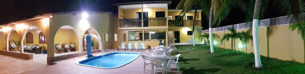 a large house with a swimming pool in the yard at Pousada Gamela do Maragogi in Maragogi