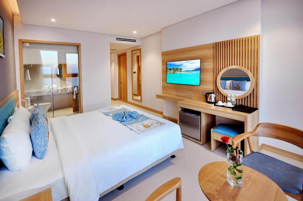 Postel nebo postele na pokoji v ubytování Sun Kiss Hotel