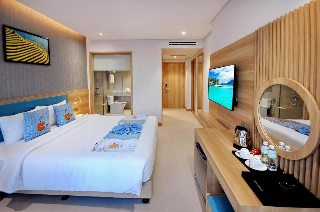 Postel nebo postele na pokoji v ubytování Sun Kiss Hotel
