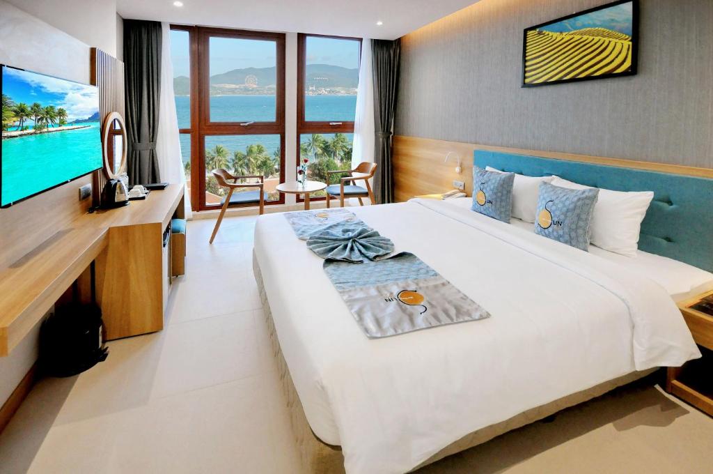 Postel nebo postele na pokoji v ubytování Sun Kiss Hotel