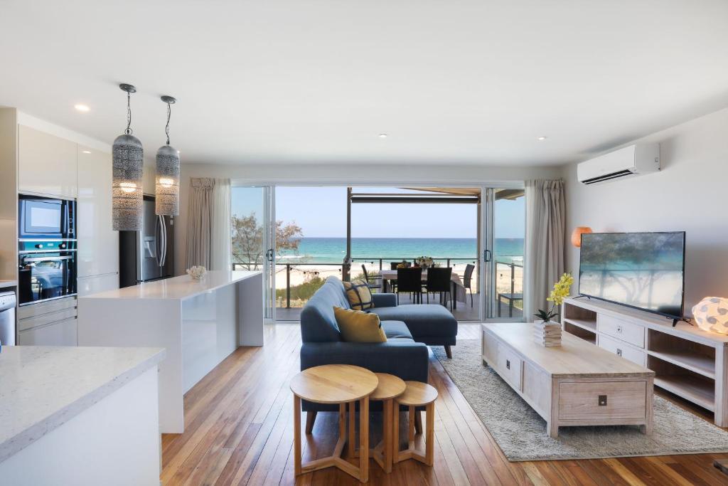 a kitchen and living room with a view of the ocean at Sandbox Apartments in Gold Coast