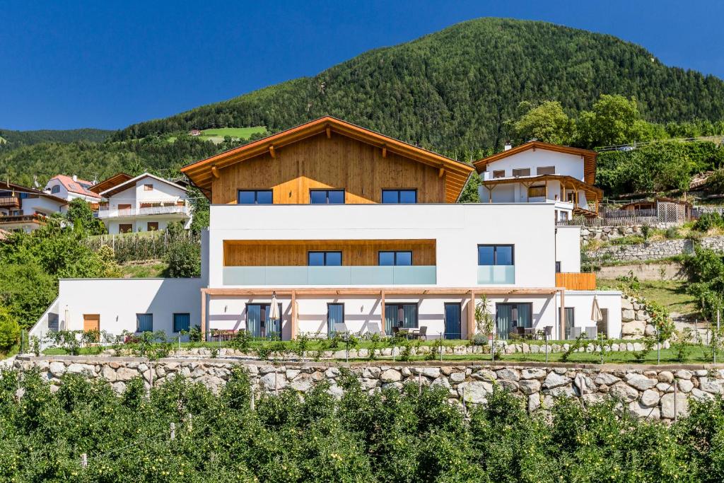 a house with a mountain in the background at Beim Dorner in Schenna