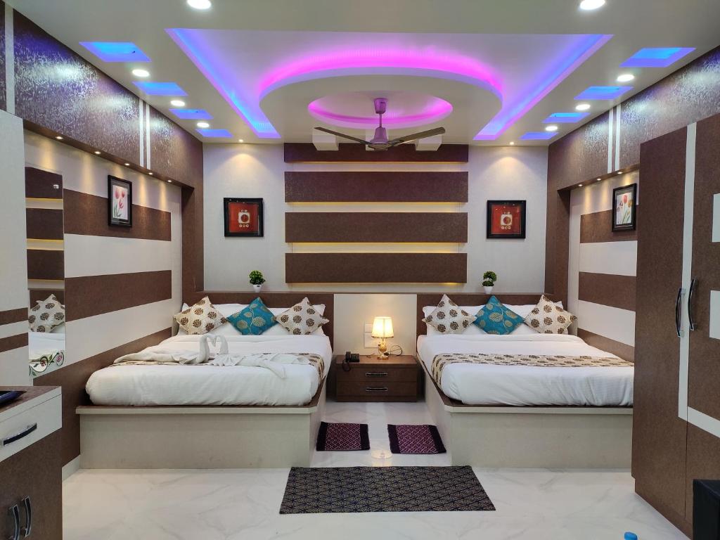 Duas camas num quarto com tecto roxo em HOTEL CENTRAL SQUARE "A Couple Friendly Hotel" em Muzaffarpur