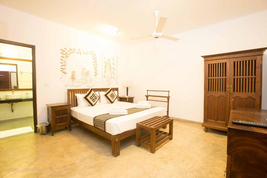 a bedroom with a bed and a ceiling fan at Jaffna Heritage Villa in Jaffna