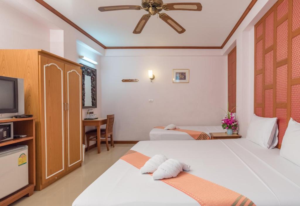 Postel nebo postele na pokoji v ubytování New Siam III Guest House