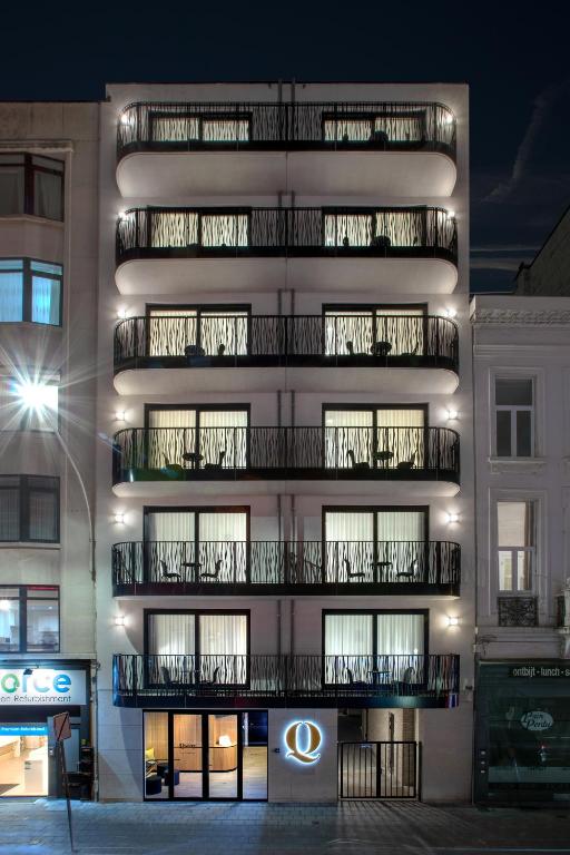 a tall building with balconies on the side of it at Q-Stay in Antwerp