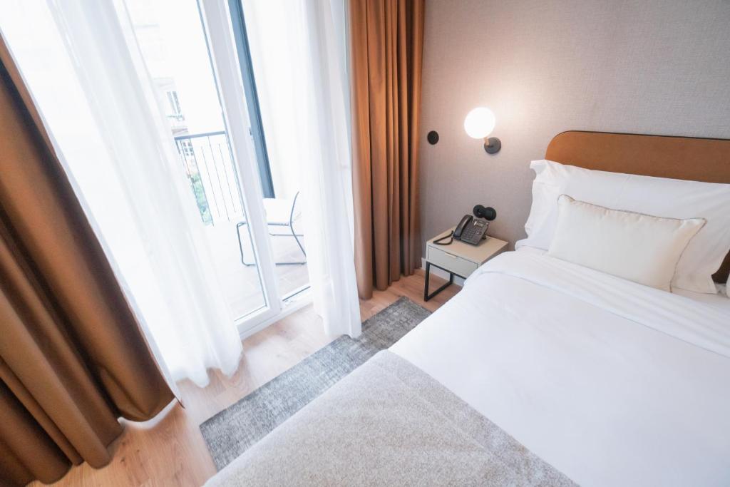Postel nebo postele na pokoji v ubytování LX SoHo Boutique Hotel by RIDAN Hotels