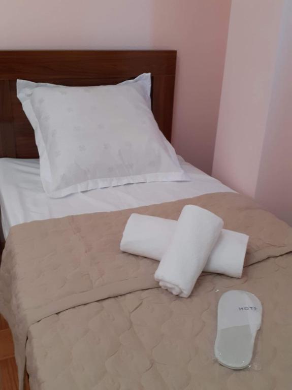 a bed with two white pillows on top of it at Guest House LIBU Zugdidi in Zugdidi