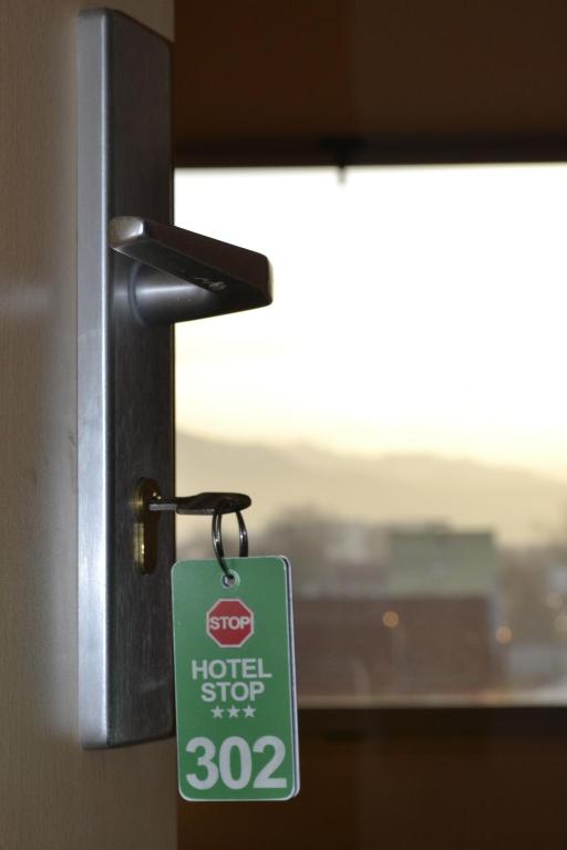 a hotel stop sign hanging from a door knob at Stop Hotel in Braşov