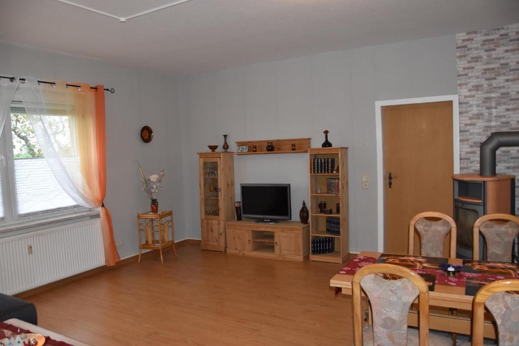 a living room with a table and a television at Flora in Galenbeck