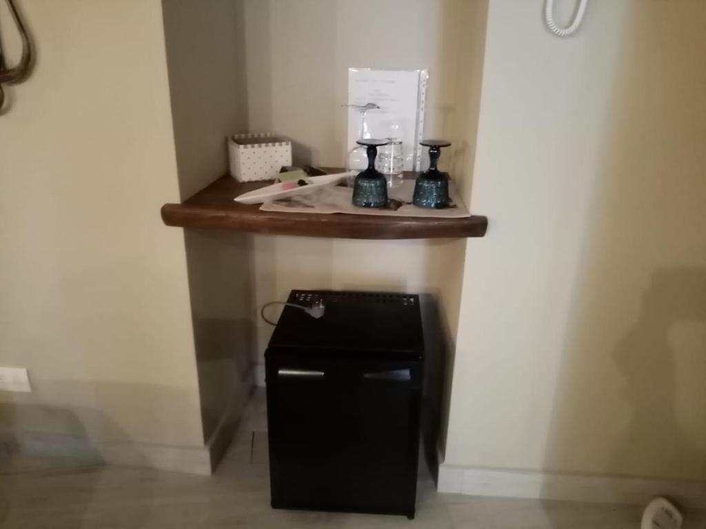 a small black refrigerator in a corner of a room at Casa D'amore in Riomaggiore