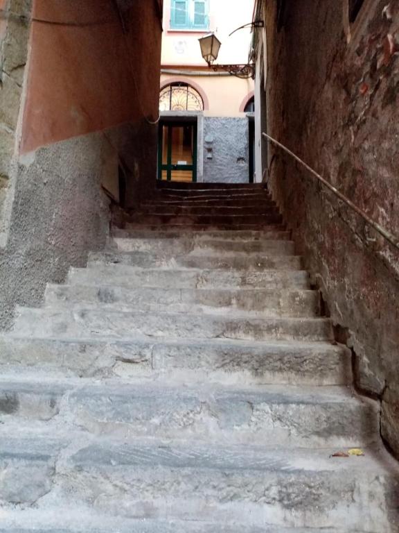 an alley with stairs leading up to a building at Casa D'amore in Riomaggiore