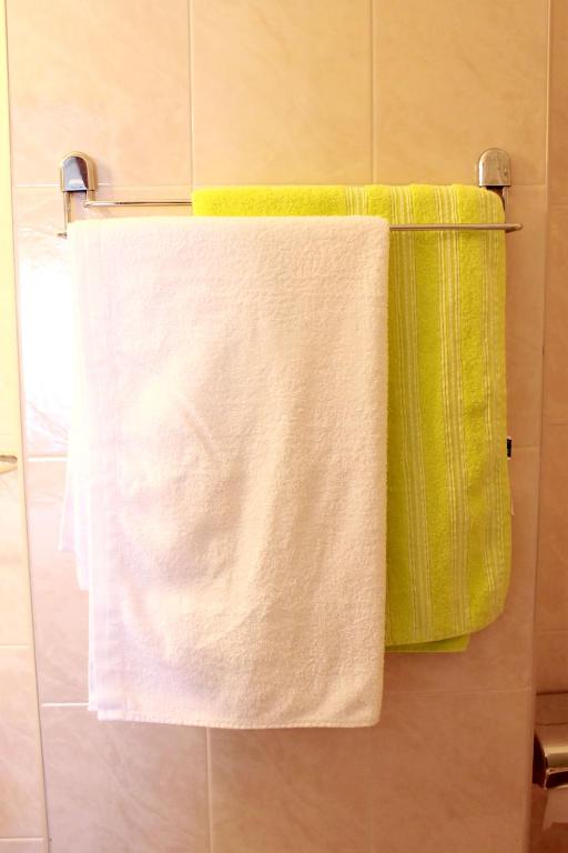 two towels hanging on a towel rack in a bathroom at ABLA Guest House in Carcavelos