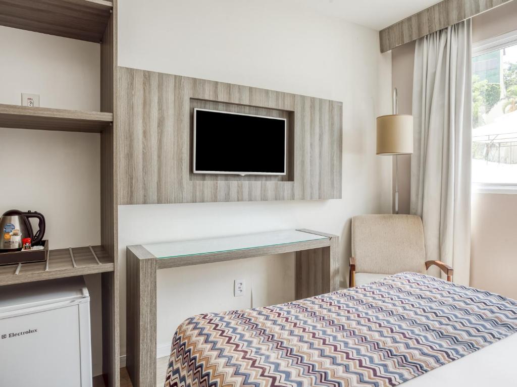 Cama ou camas em um quarto em CHA Pampulha Design Hotel