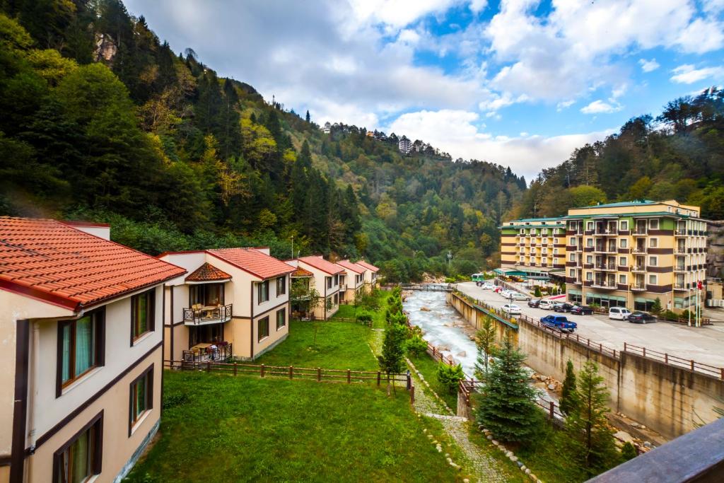 a view of a town with a river and buildings at Ridos Thermal Hotel & Spa in Kürreiseba