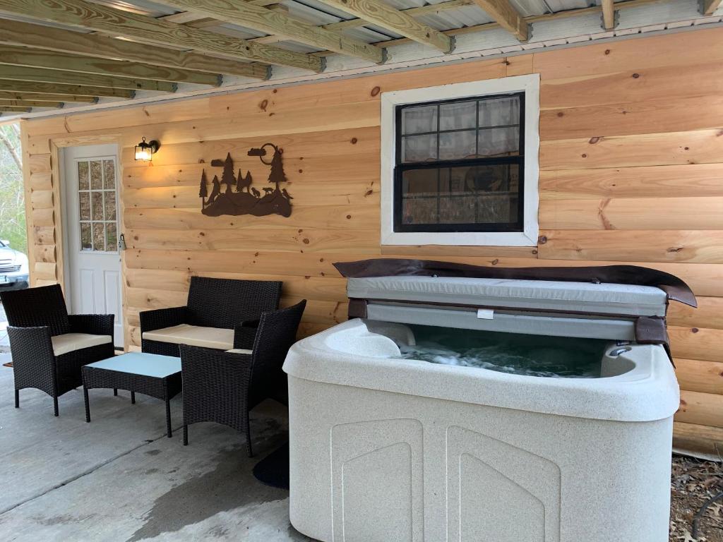 a patio with a hot tub in a house at Wild Reindeer 5min From Parkway HOTTUB FIREpit in Sevierville