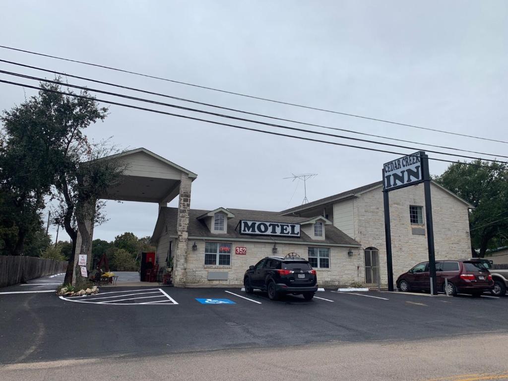 a car parked in a parking lot in front of a motel at Cedar Creek Inn in Bertram