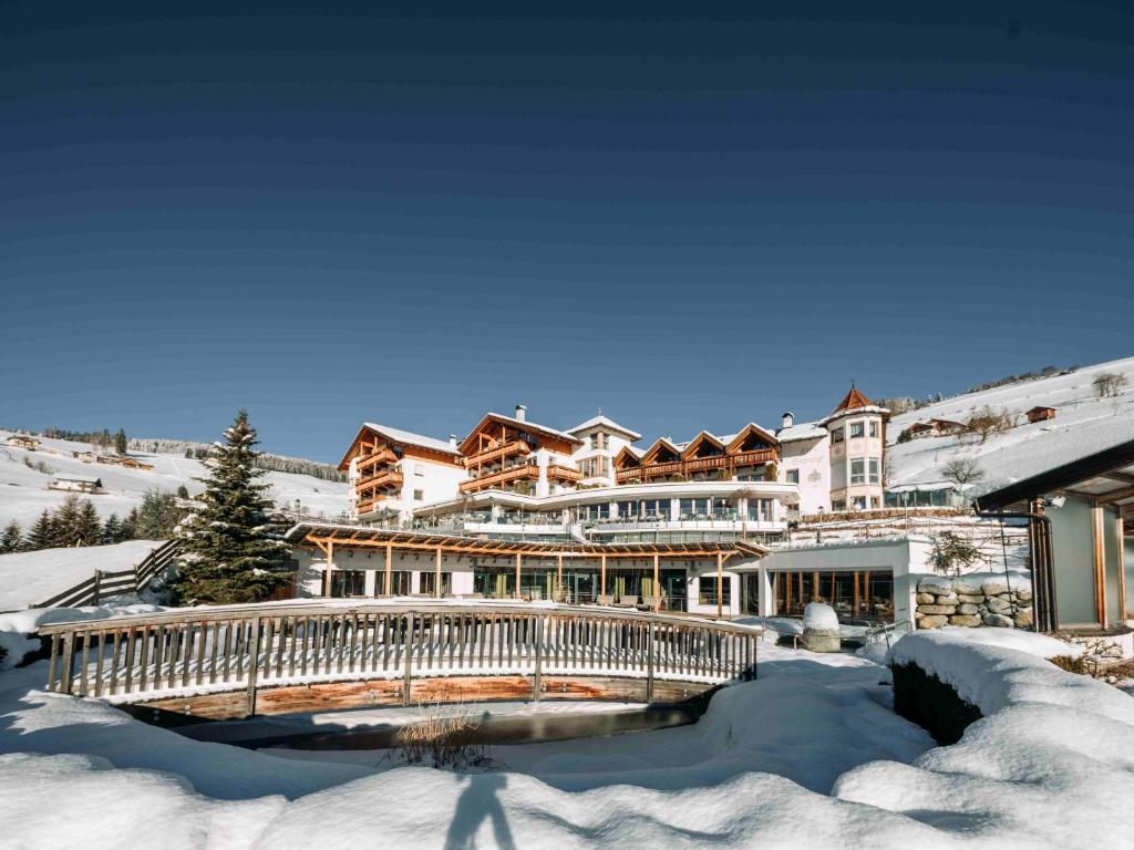 a large house in the snow with a bridge at Hotel Bacherhof in Maranza