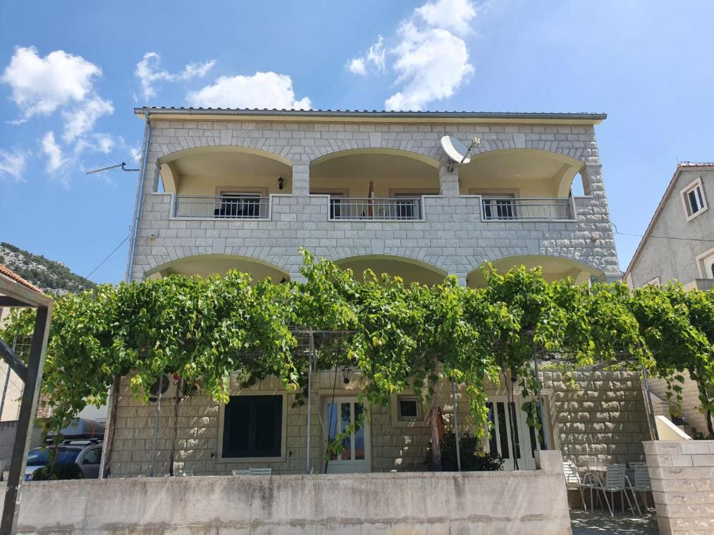 a building with trees in front of it at Apartments Gojevic in Bol