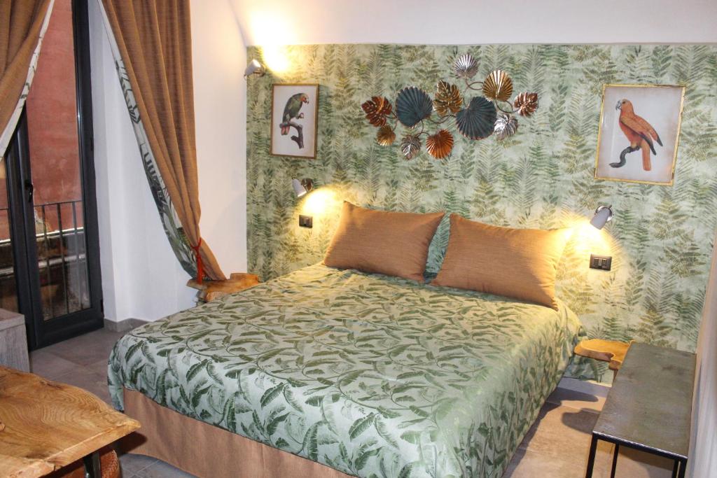 a bedroom with a bed with a green comforter at B&B Quispaccanapoli in Naples