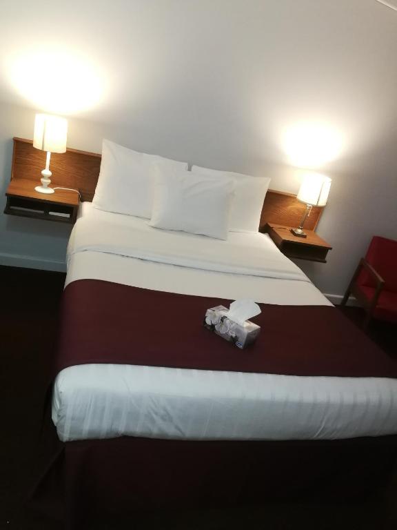 Postel nebo postele na pokoji v ubytování Sundowner Motel