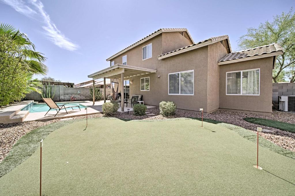 a house with a putting green in front of a house at Goodyear Home with Pool, 2 Mi to Goodyear Ballpark in Goodyear